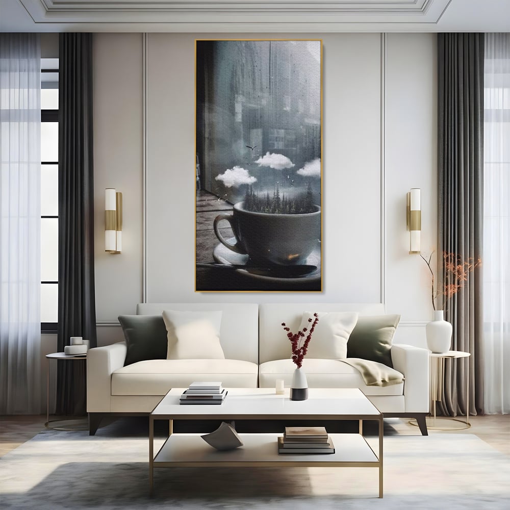 Tablou canvas cu ceasca de cafea cu padure si nori, in rama de aluminiu auriu, pe perete intr-un living